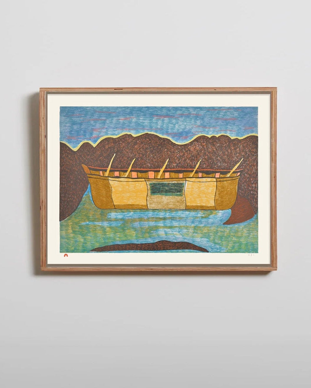 Framed artwork of a boat on water with mountains in the background on a light gray wall.