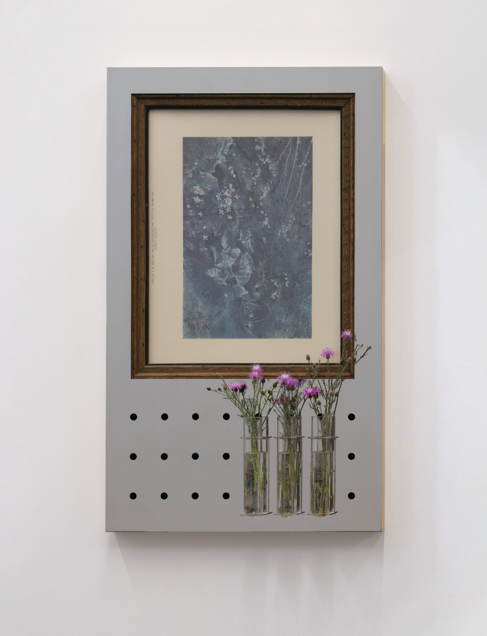 Mirror wall art with framed vintage print and small vases holding flowers on a white background