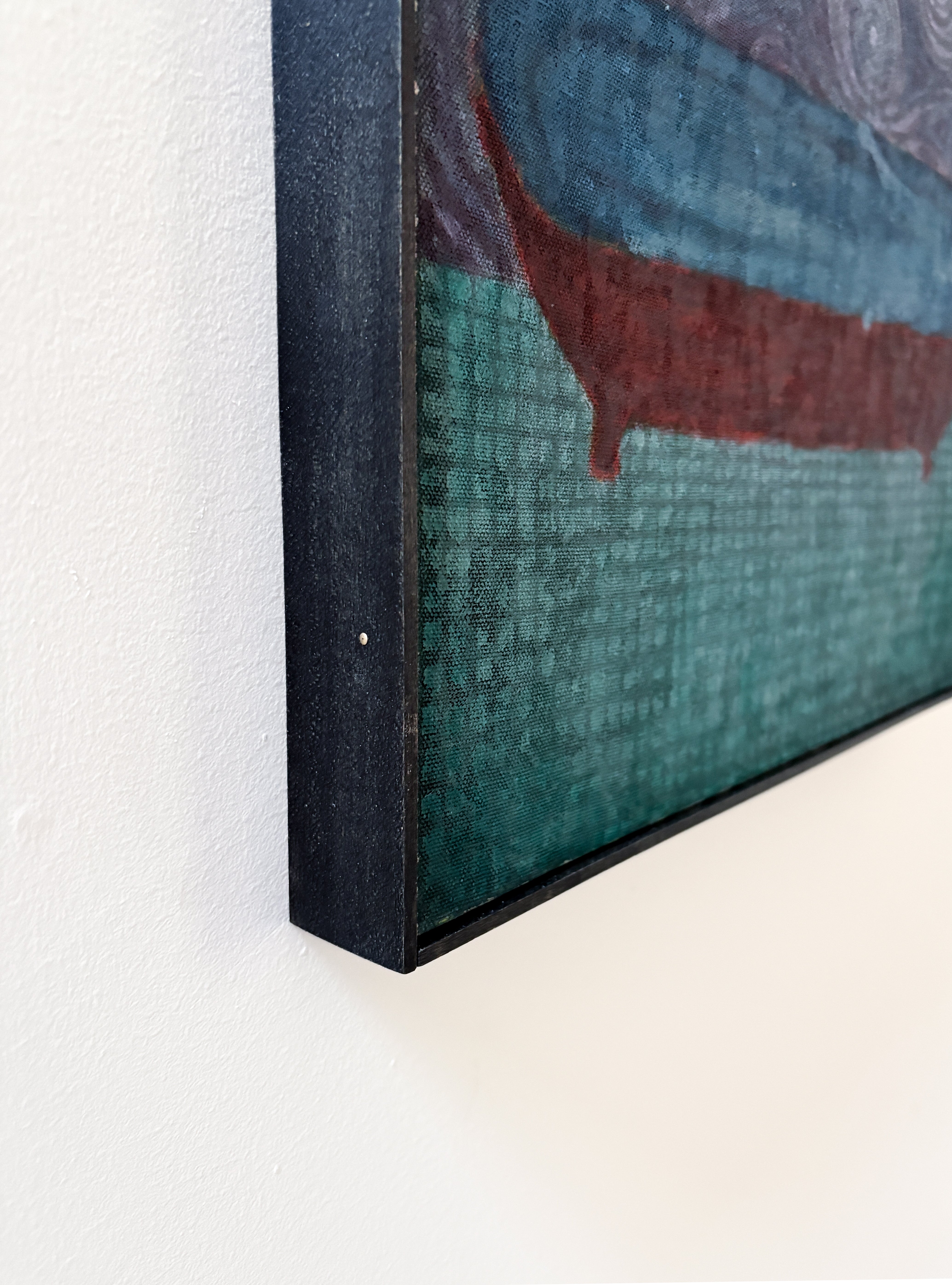 Close-up of a textured painting with a dark frame on a white background