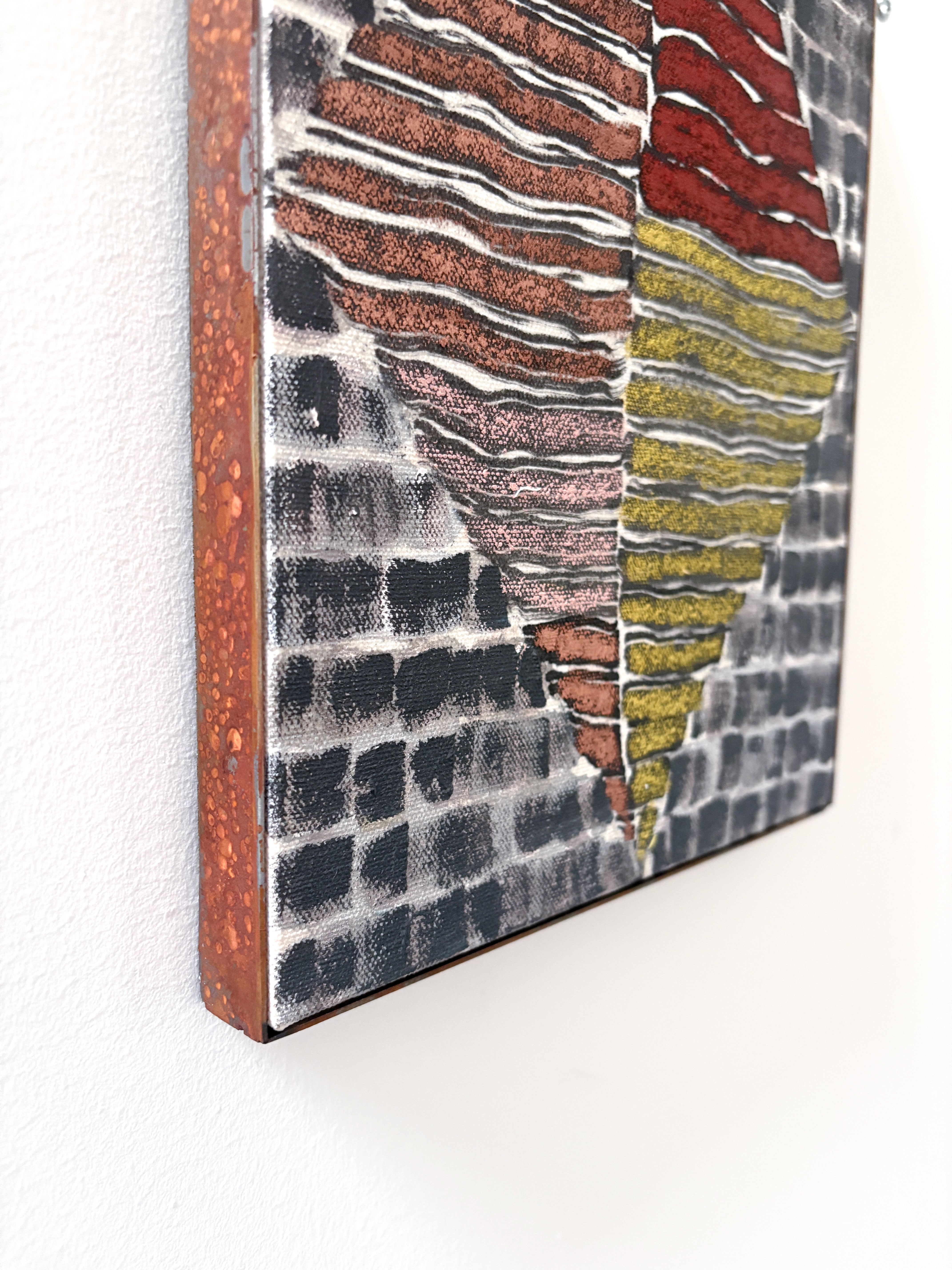 Abstract art piece with wavy patterns in red, yellow, and black on a textured surface.