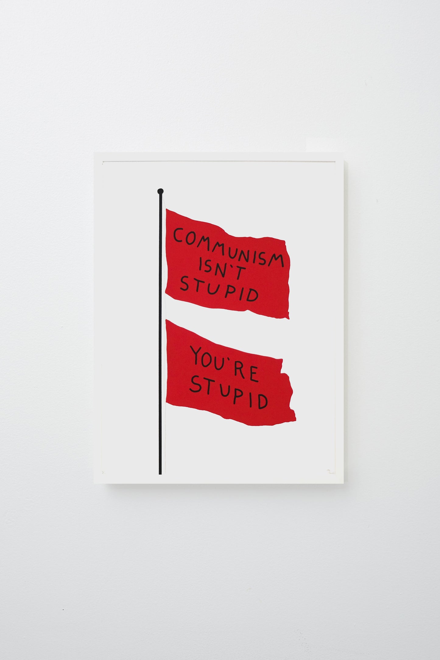 2 flags on a pole, flags read 'COMMUNISM ISN'T STUPID YOU'RE STUPID' in black text. Framed on white wall.