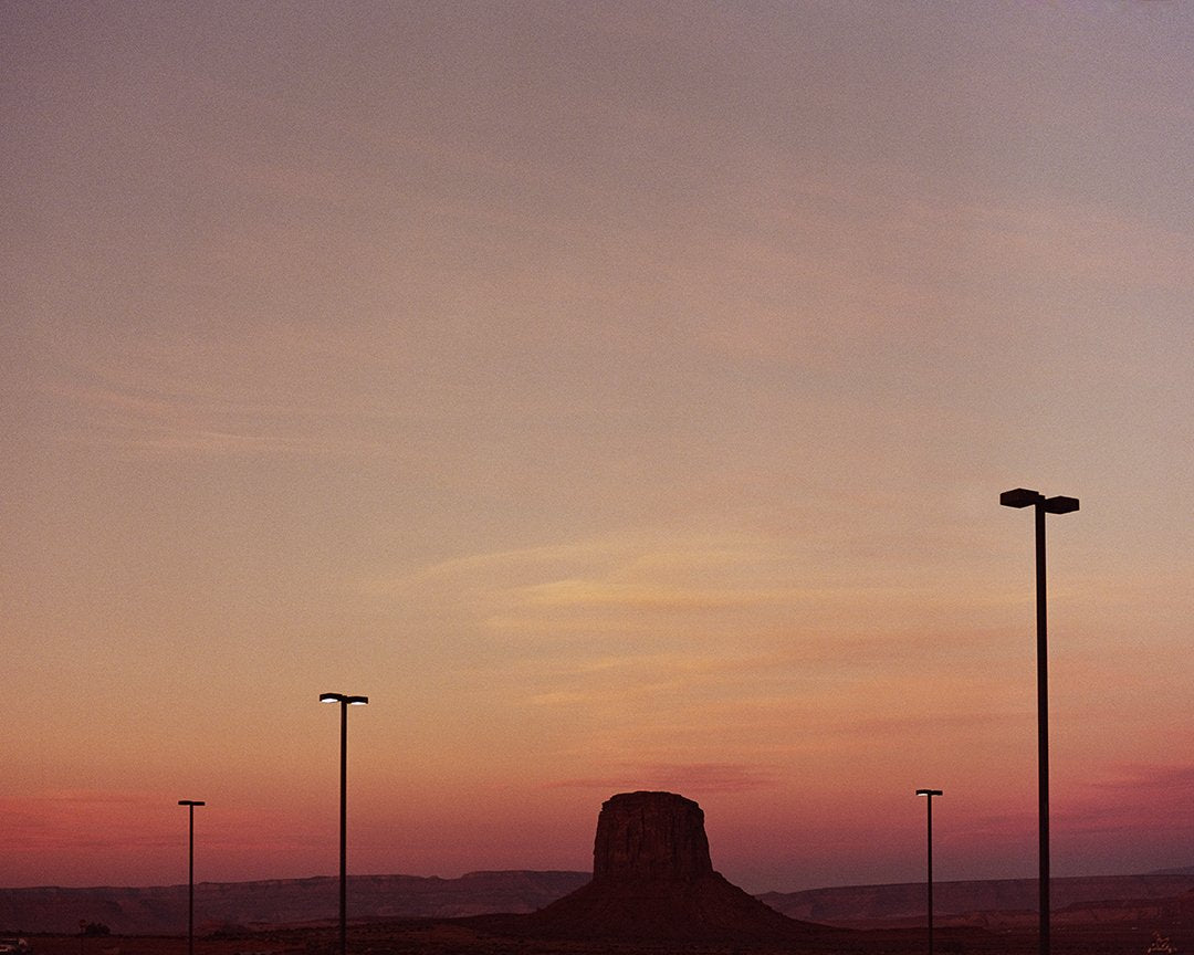 Rock formation extending from the ground at sunset, unframed.